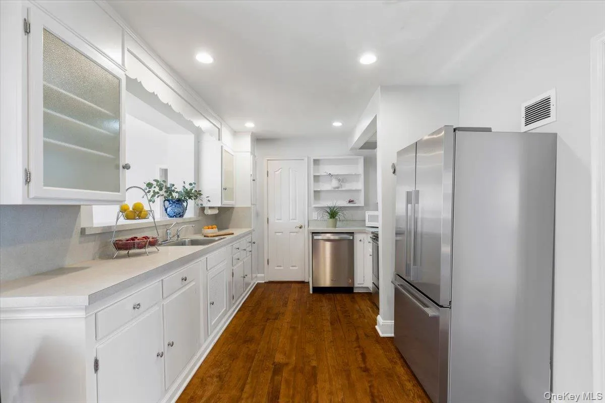 Kitchen with stainless steel appliances, and showing door to pantry Kitchen with stainless steel appliances, and showing door to pantry