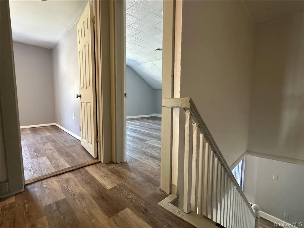 Corridor featuring hardwood / wood-style floors Corridor featuring hardwood / wood-style floors