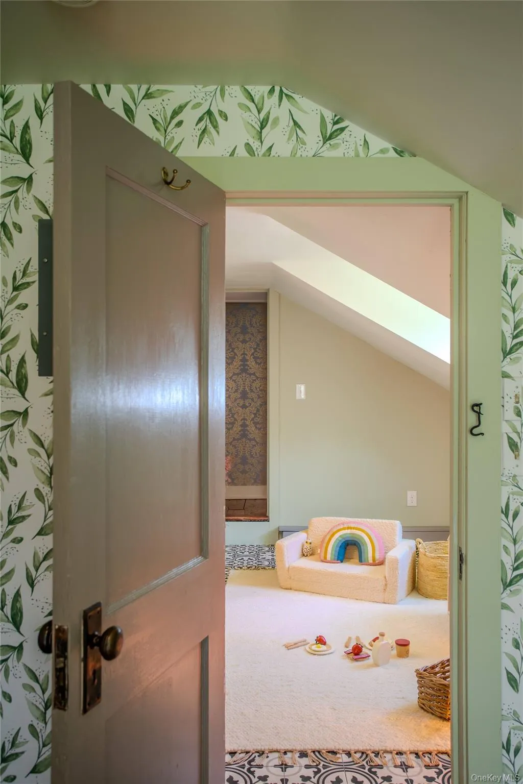 Loft space with sloped ceilings, decorative floor tile, patterned accents, and a skylight. Loft space with sloped ceilings, decorative floor tile, patterned accents, and a skylight.