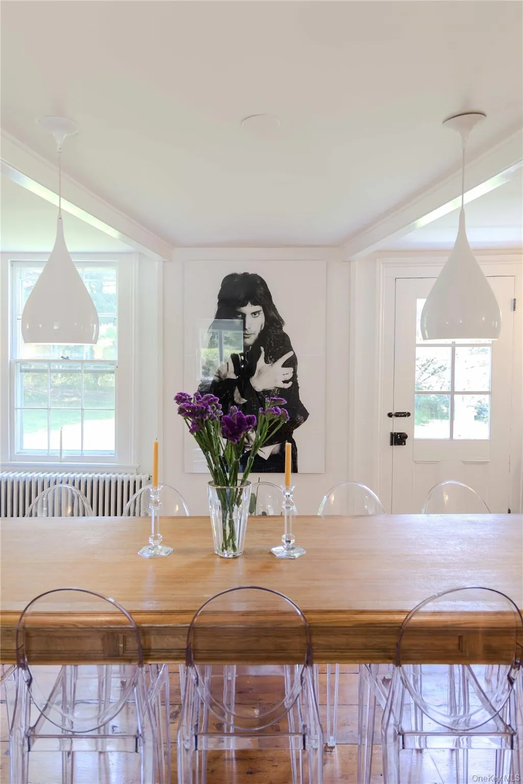 Dining area featuring a wood-finish table, dual contemporary pendant lights, and classic white trim throughout Dining area featuring a wood-finish table, dual contemporary pendant lights, and classic white trim throughout