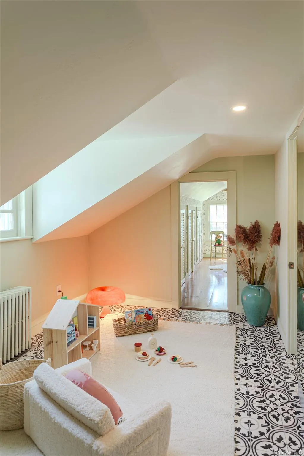 Loft space with sloped ceilings, decorative floor tile, patterned accents, and a skylight. Loft space with sloped ceilings, decorative floor tile, patterned accents, and a skylight.