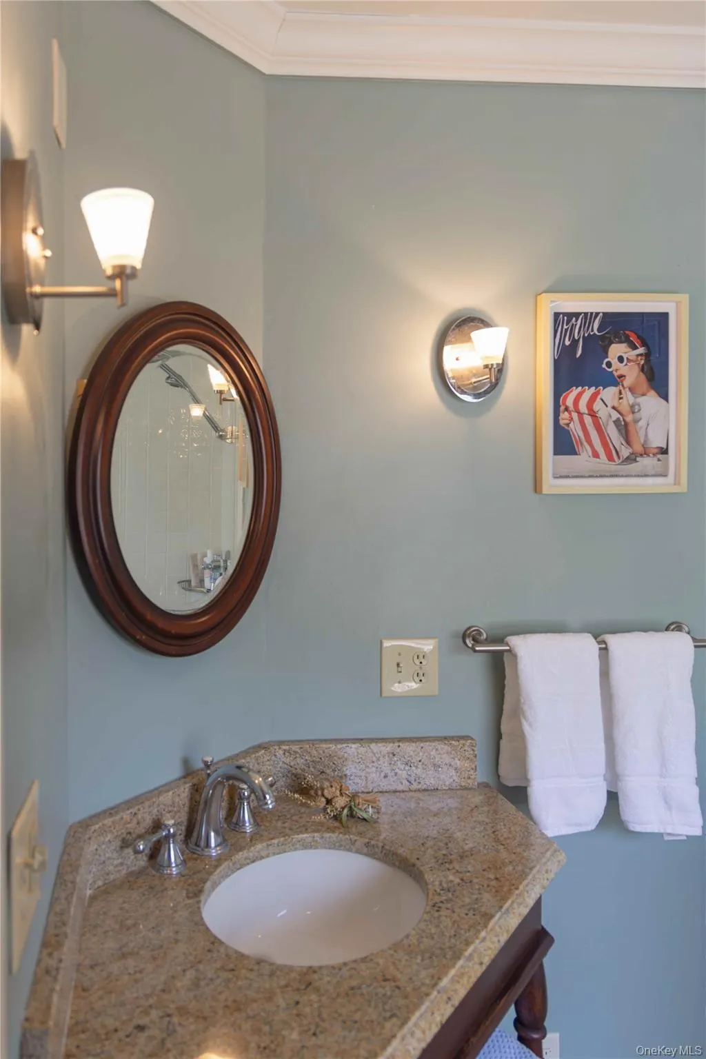 Bathroom vanity featuring a granite countertop, undermount sink, and chrome-finish faucet Bathroom vanity featuring a granite countertop, undermount sink, and chrome-finish faucet