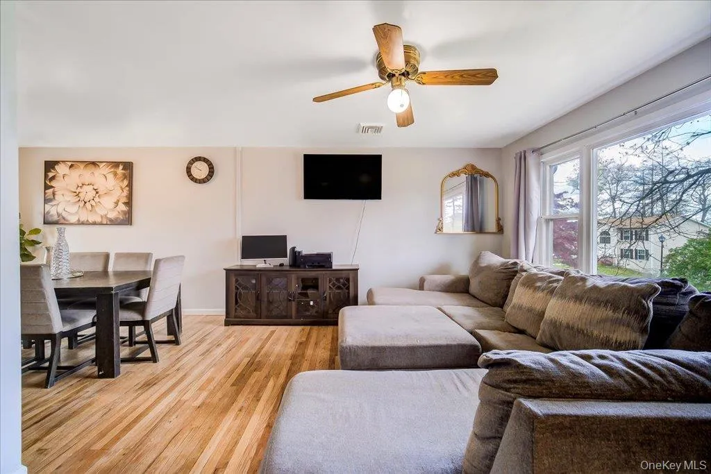 Open-concept living room with a partial view of the dining area. Open-concept living room with a partial view of the dining area.