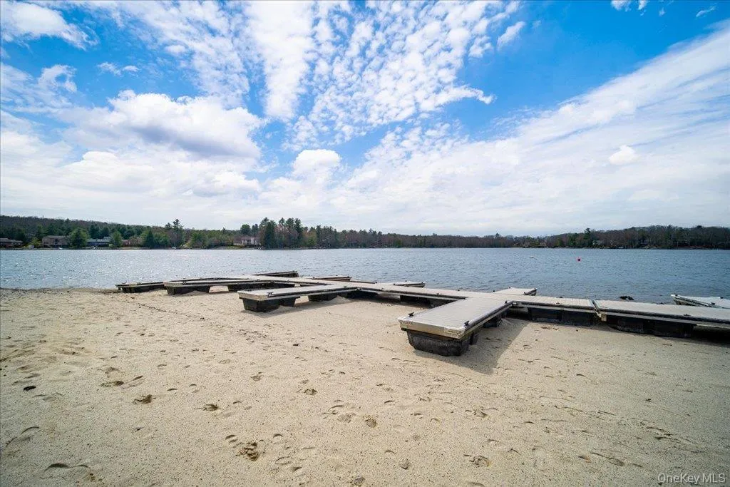 Sandy beach frontage featuring multiple floating docks Sandy beach frontage featuring multiple floating docks