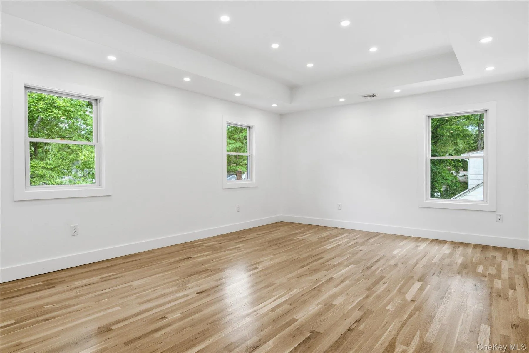 Large Primary Bedroom with tray ceilings and high hats Large Primary Bedroom with tray ceilings and high hats