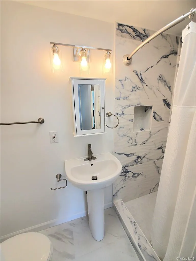Bathroom featuring toilet and tile patterned floors Bathroom featuring toilet and tile patterned floors