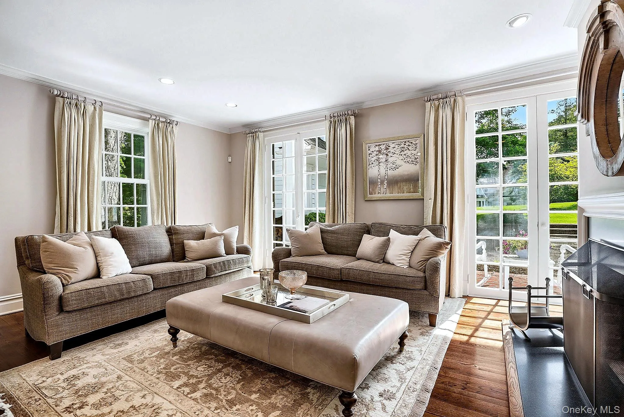 Living Room w/ Hardwood Flooring and Woodburning Fireplace. Floor to Ceiling Windows. Living Room w/ Hardwood Flooring and Woodburning Fireplace. Floor to Ceiling Windows.