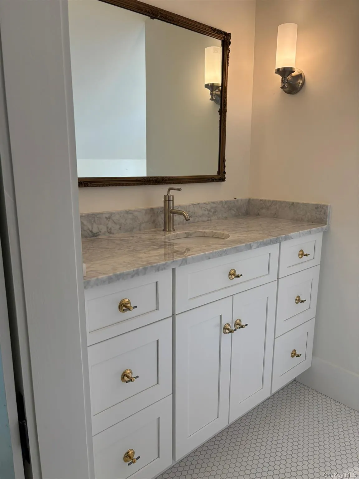 The primary bath includes a quartz vanity top, tiled walk-in shower and laundry. The primary bath includes a quartz vanity top, tiled walk-in shower and laundry.