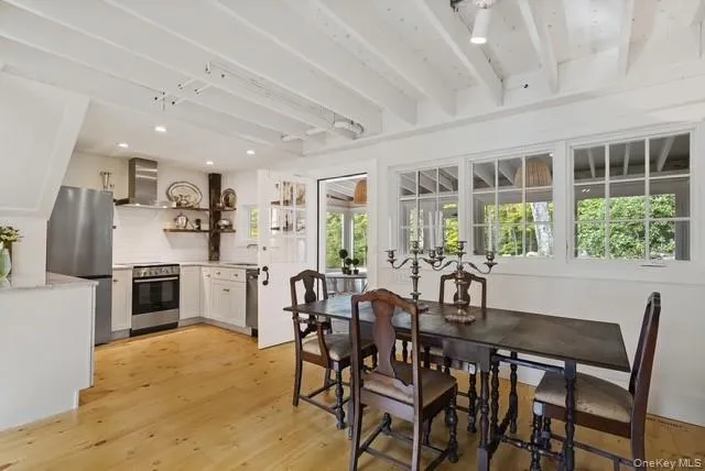 From the screened porch you enter into the open kitchen/dining area with the adjoining living room. From the screened porch you enter into the open kitchen/dining area with the adjoining living room.