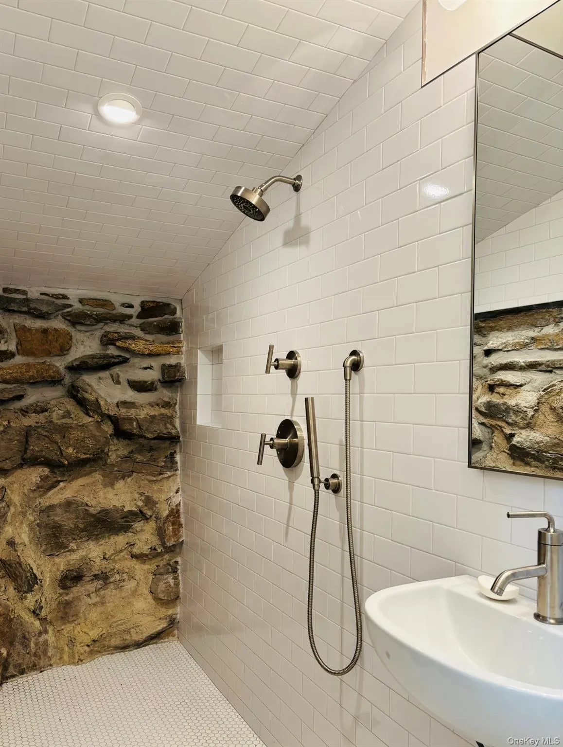 A special feature in the shower: a river rock foundation wall. A special feature in the shower: a river rock foundation wall.