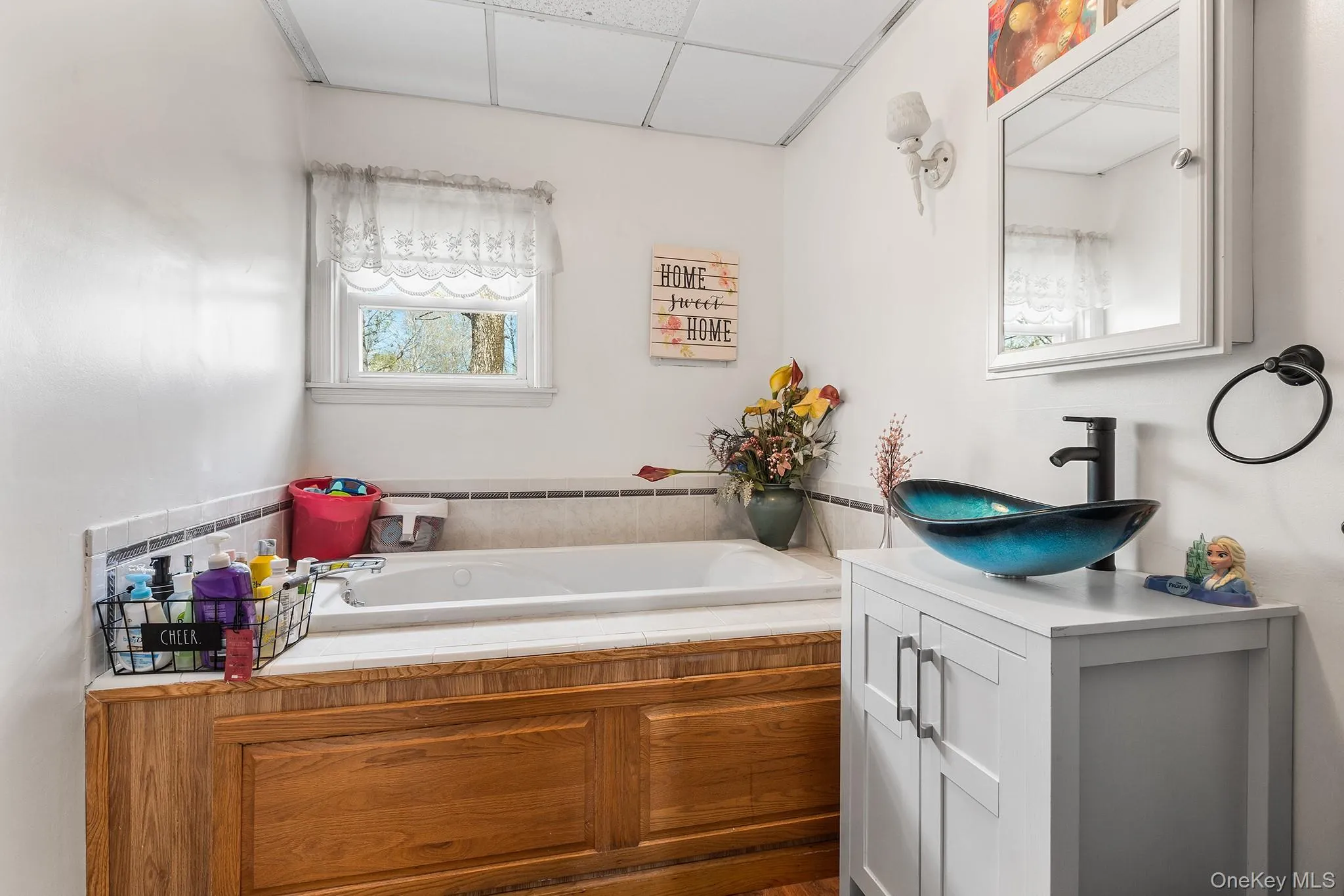 Soaking tub with tiled surround and wood-finish paneling Soaking tub with tiled surround and wood-finish paneling