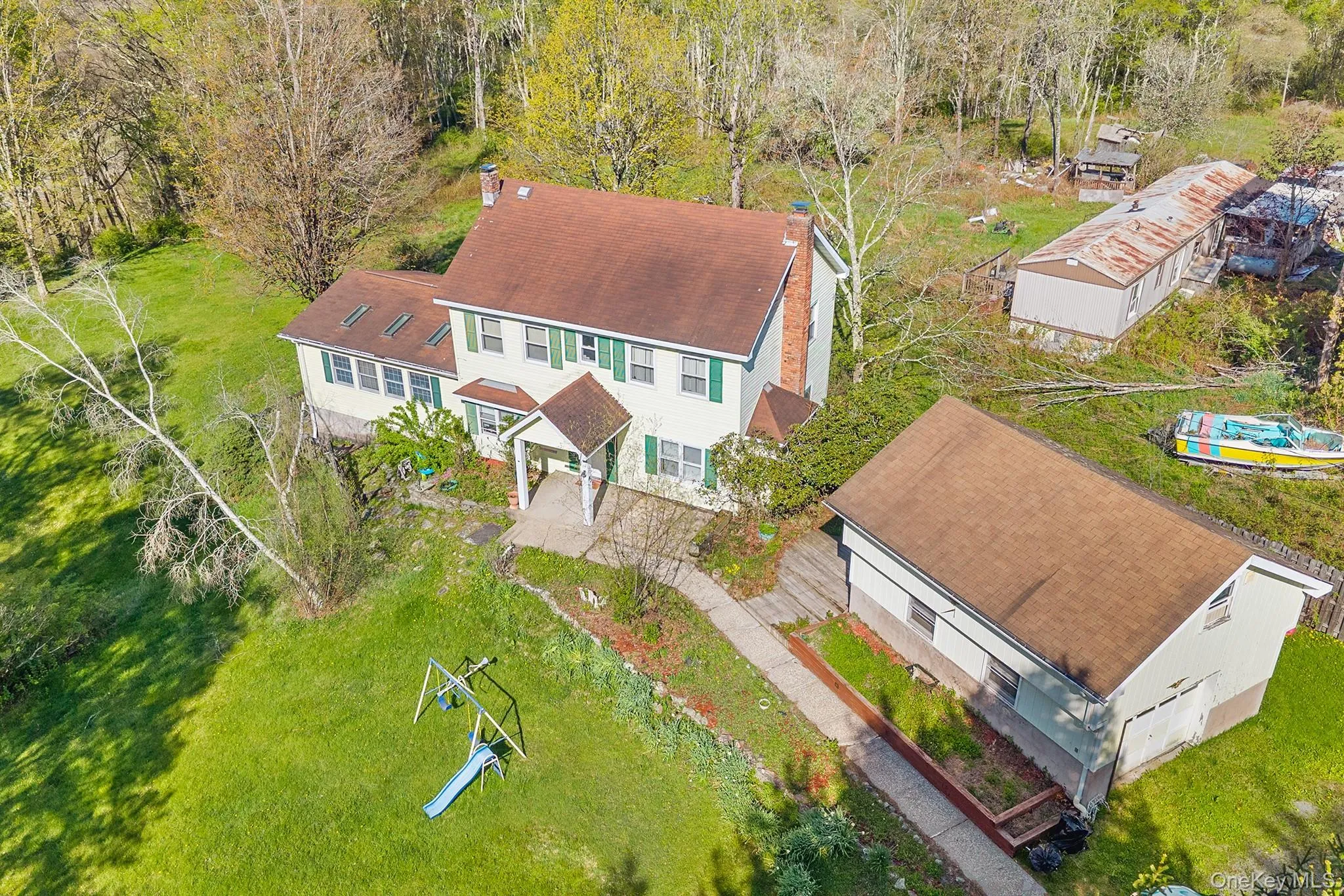 Two-story residence with a covered front entry and shuttered windows Two-story residence with a covered front entry and shuttered windows