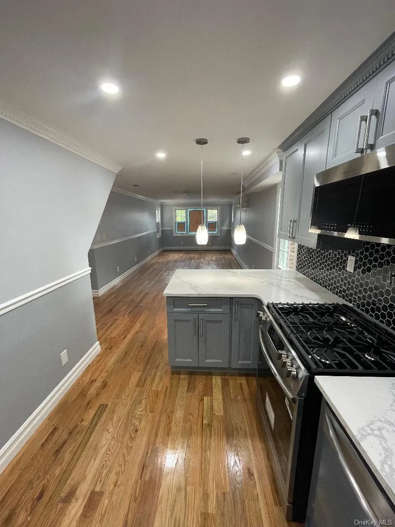 Kitchen with Cabinetry and Stainless Steel Appliances and Lighting Kitchen with Cabinetry and Stainless Steel Appliances and Lighting