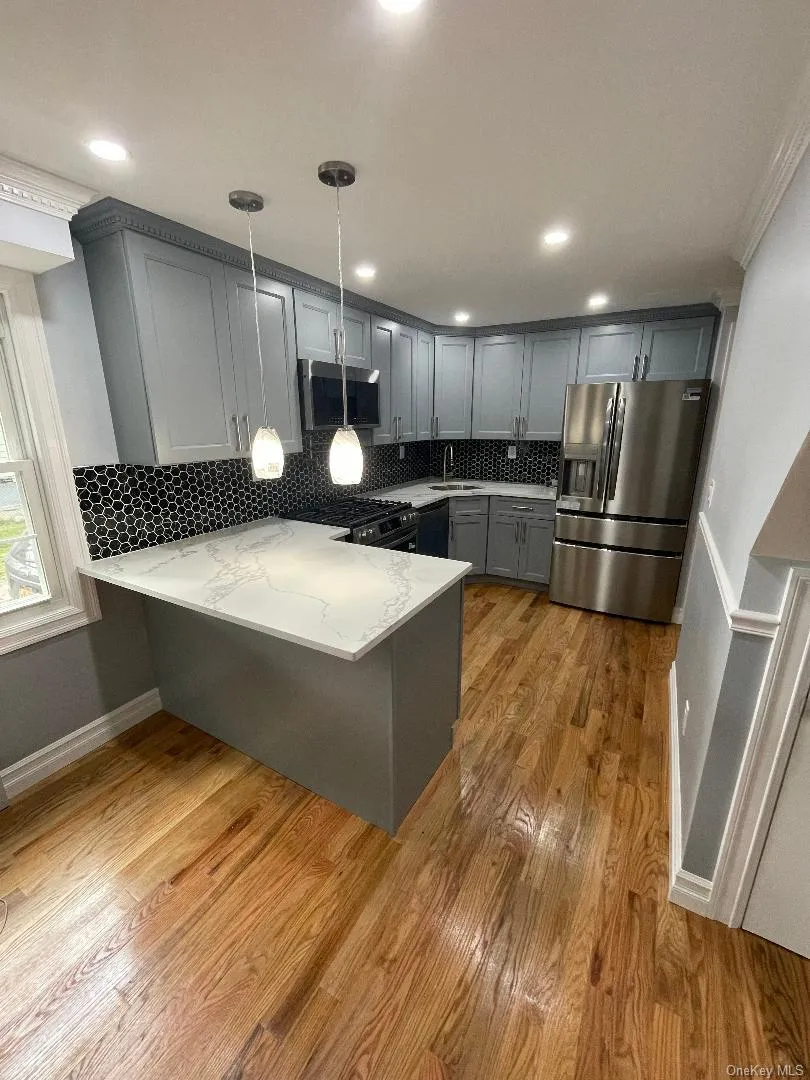 Kitchen with Cabinetry and StainlessSteel Appliances and Lighting Kitchen with Cabinetry and StainlessSteel Appliances and Lighting