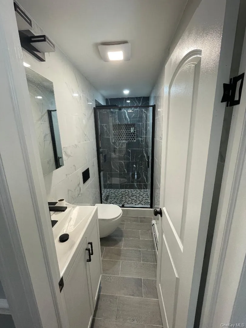 Full Bathroom with Vanity, Toilet and Glass Shower Door Full Bathroom with Vanity, Toilet and Glass Shower Door