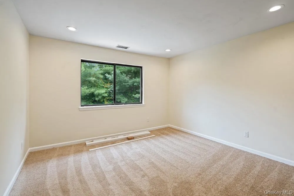 Neutral-toned carpeting and walls complement recessed lighting, providing a bright and spacious interior Neutral-toned carpeting and walls complement recessed lighting, providing a bright and spacious interior