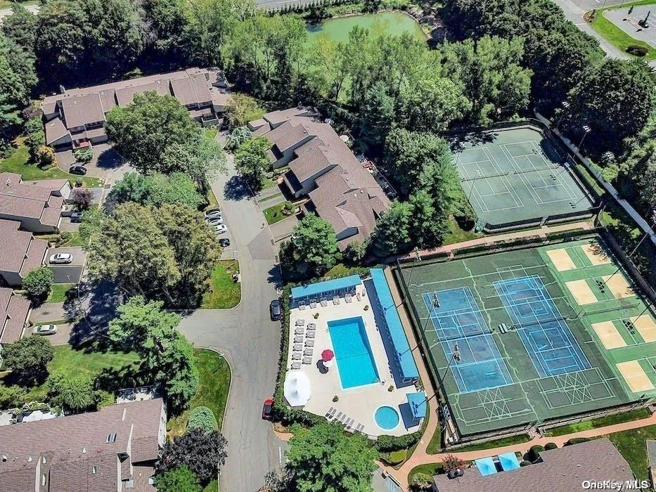 Community amenities featuring a swimming pool, separate hot tub, multiple tennis courts, and pickleball courts Community amenities featuring a swimming pool, separate hot tub, multiple tennis courts, and pickleball courts