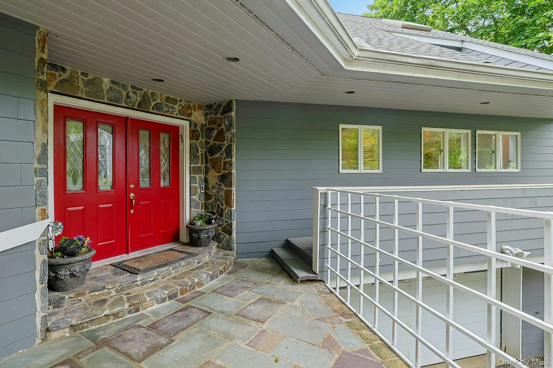 Welcoming front entrance with patio Welcoming front entrance with patio