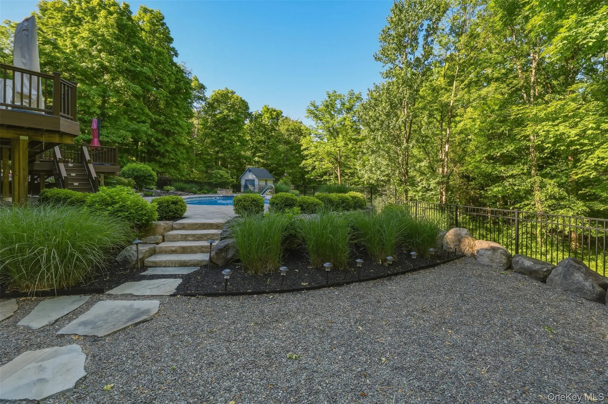 Entry from driveway to pool area Entry from driveway to pool area