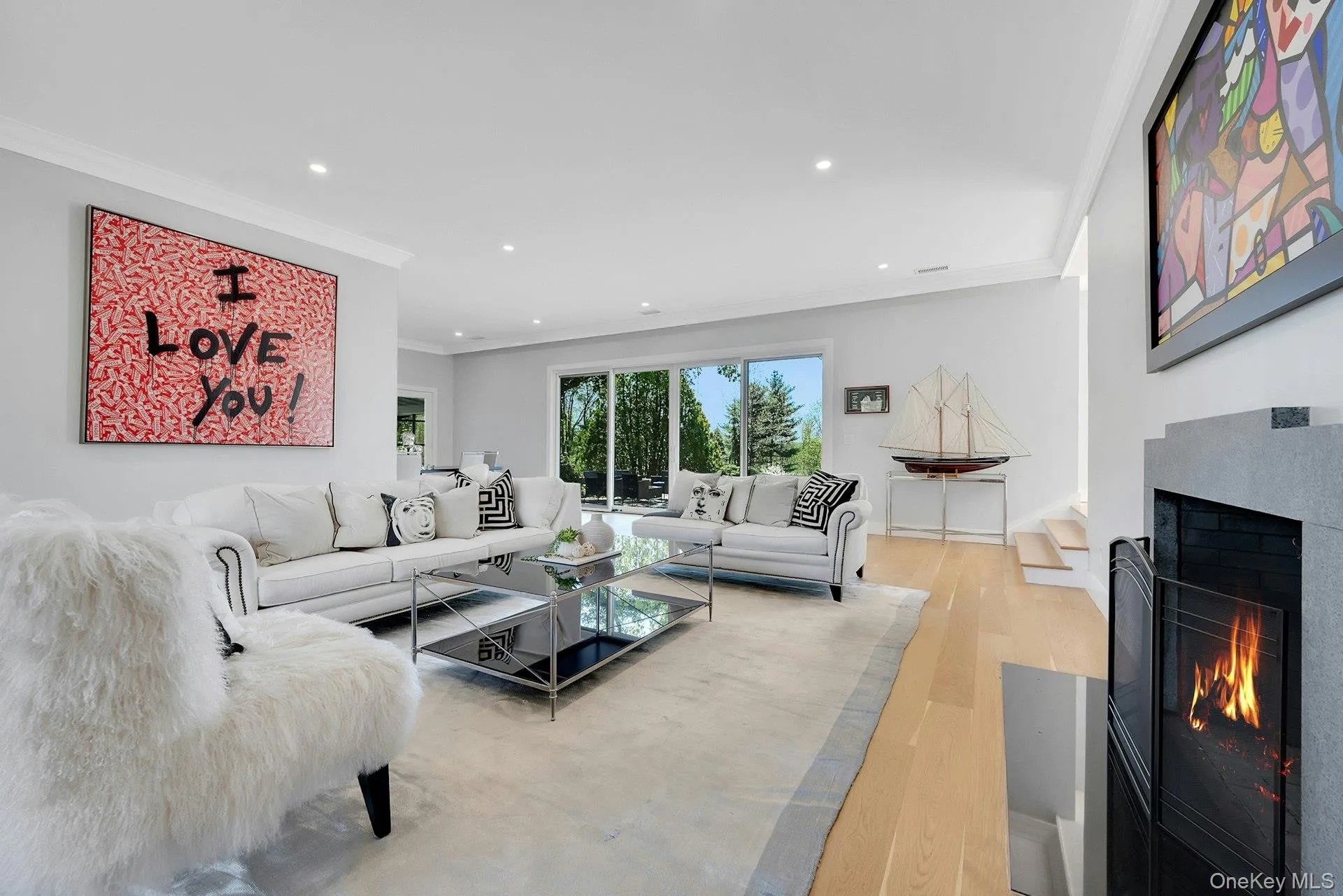 Spacious living room with two large sliding doors to the backyard patio overlooking the Cross River Reservoir Spacious living room with two large sliding doors to the backyard patio overlooking the Cross River Reservoir
