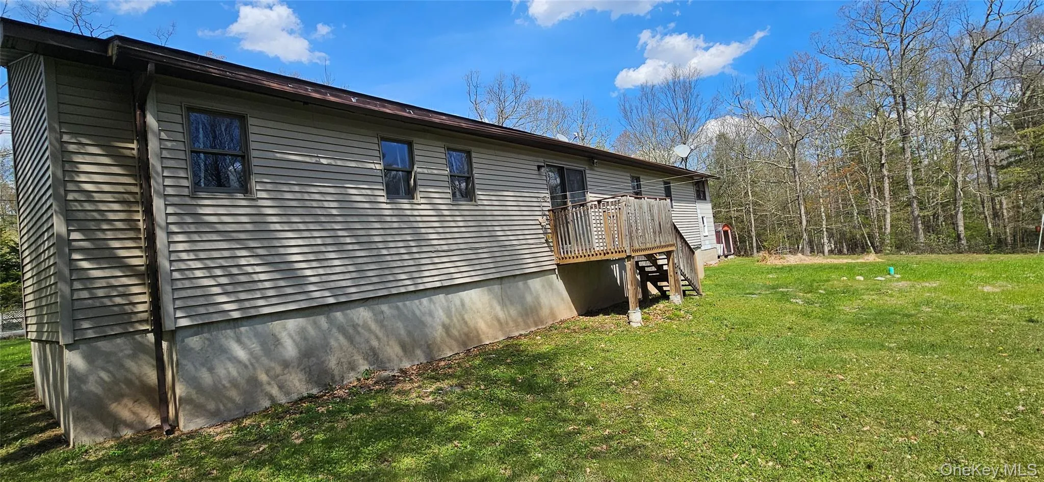 Exterior siding with multiple windows and a rear deck Exterior siding with multiple windows and a rear deck