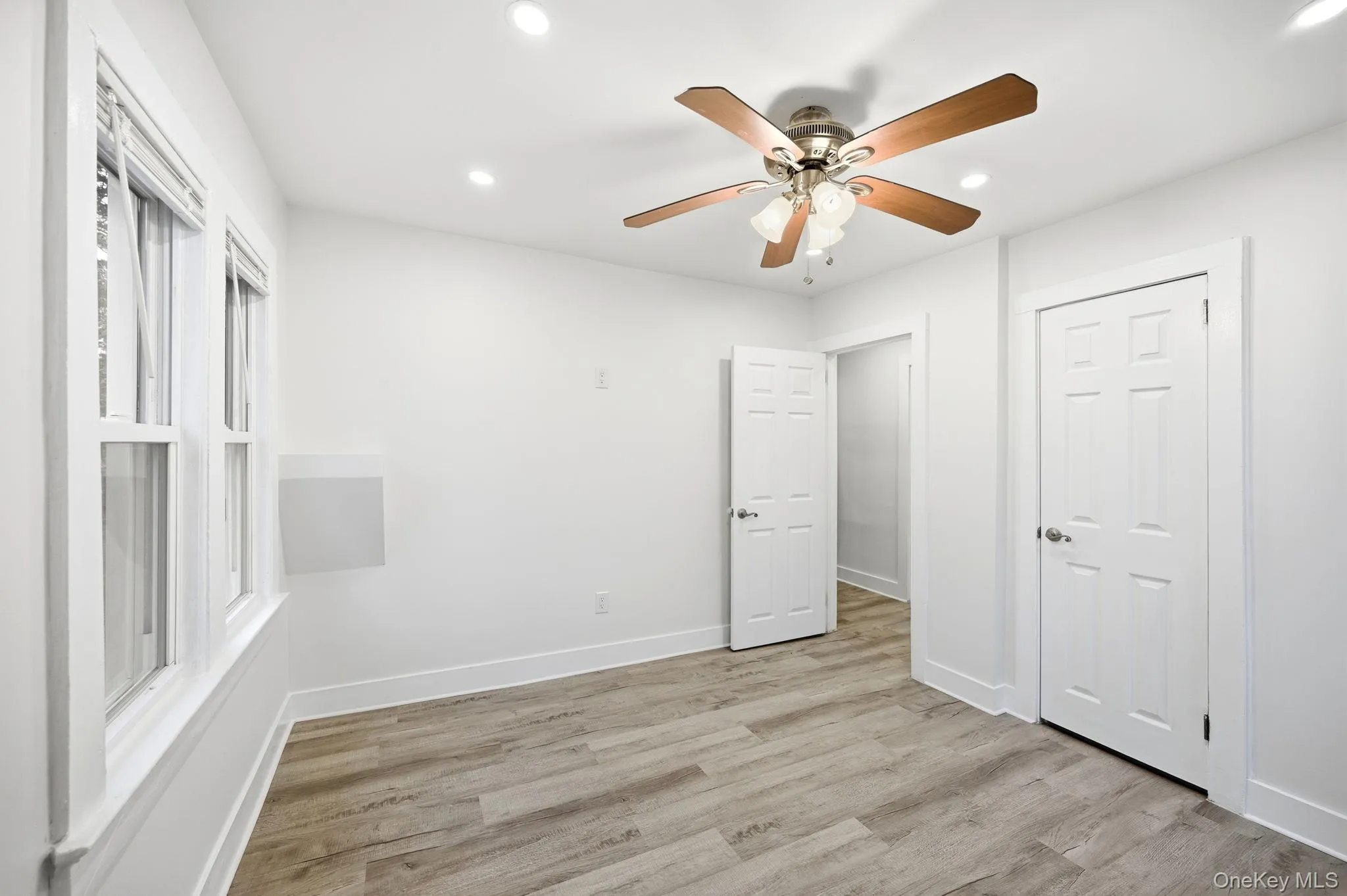 Unfurnished bedroom with ceiling fan, light wood-style flooring, and recessed lighting Unfurnished bedroom with ceiling fan, light wood-style flooring, and recessed lighting