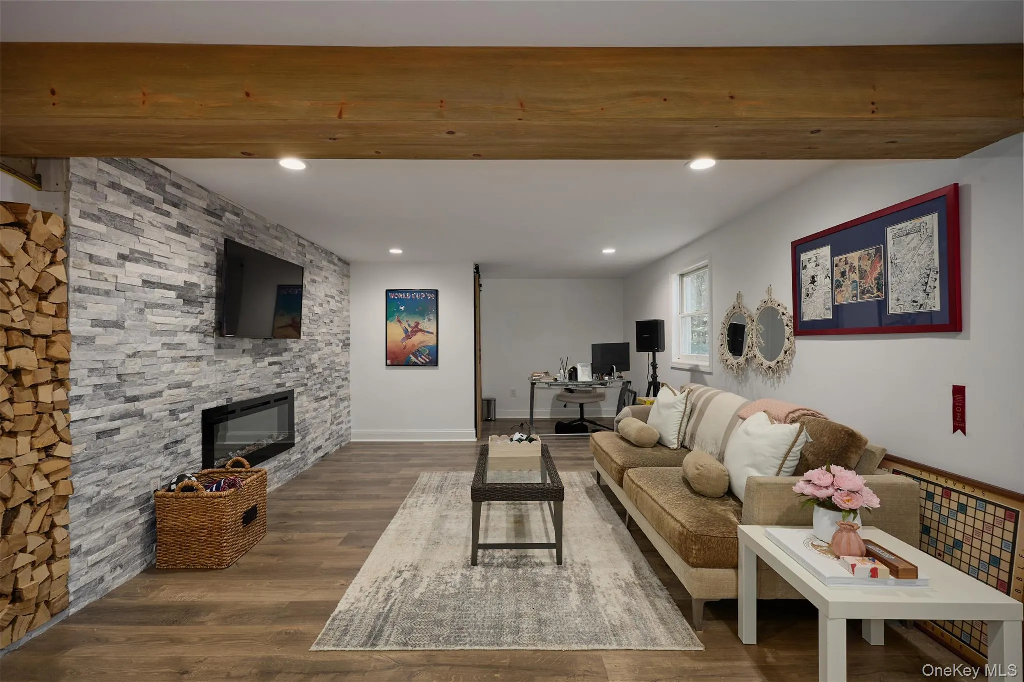 Stacked stone accents, exposed wood beams, & electric fireplace create a warm and inviting space for relaxing or entertaining Stacked stone accents, exposed wood beams, & electric fireplace create a warm and inviting space for relaxing or entertaining