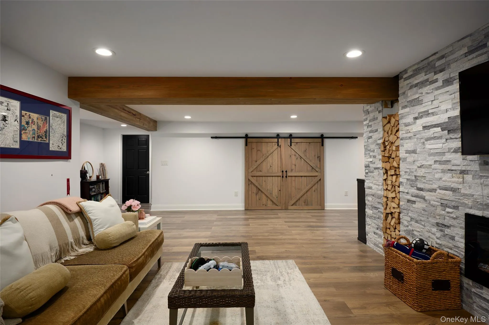 Thoughtfully finished with stacked stone, wood beams, and an electric fireplace Thoughtfully finished with stacked stone, wood beams, and an electric fireplace