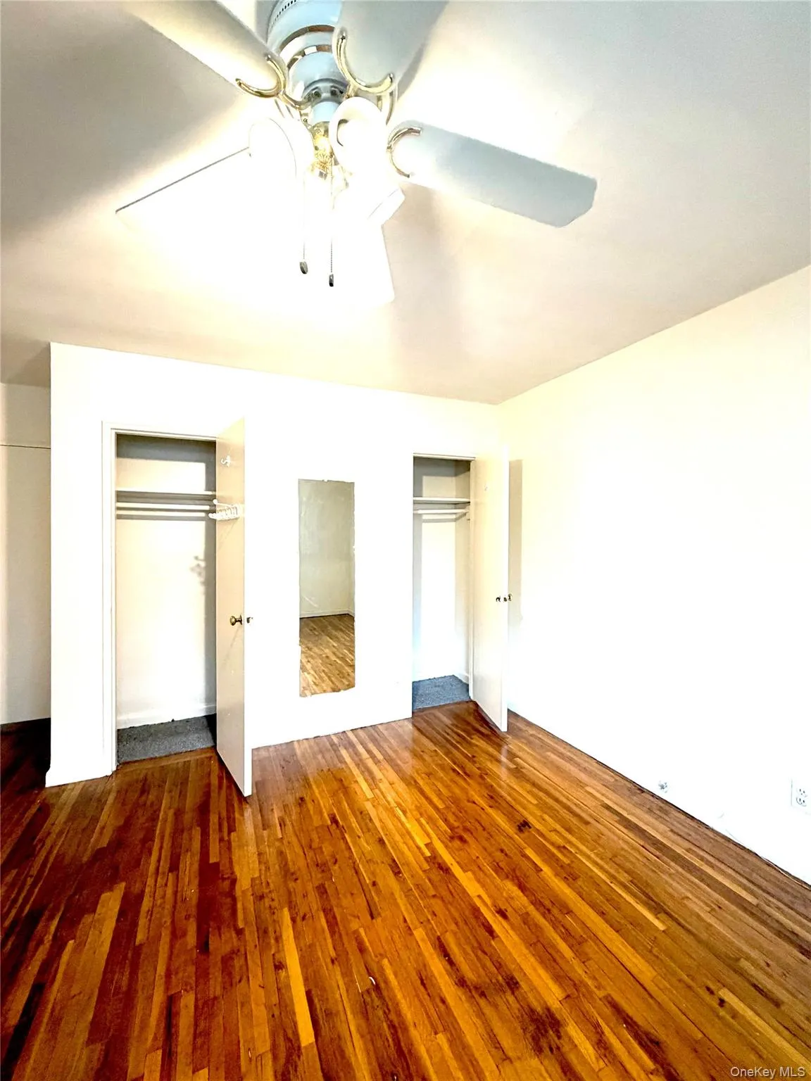 Master bedroom- double closets & Hardwood flooring throughout the room, complemented by a ceiling fan with integrated lighting Master bedroom- double closets & Hardwood flooring throughout the room, complemented by a ceiling fan with integrated lighting
