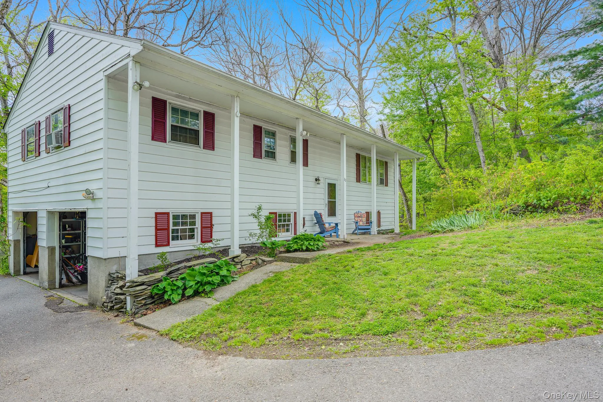 White siding residence with red shutters and a covered porch White siding residence with red shutters and a covered porch