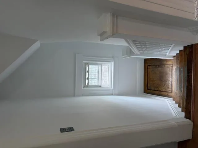 Staircase with wood-finish treads and a white painted balustrade Staircase with wood-finish treads and a white painted balustrade