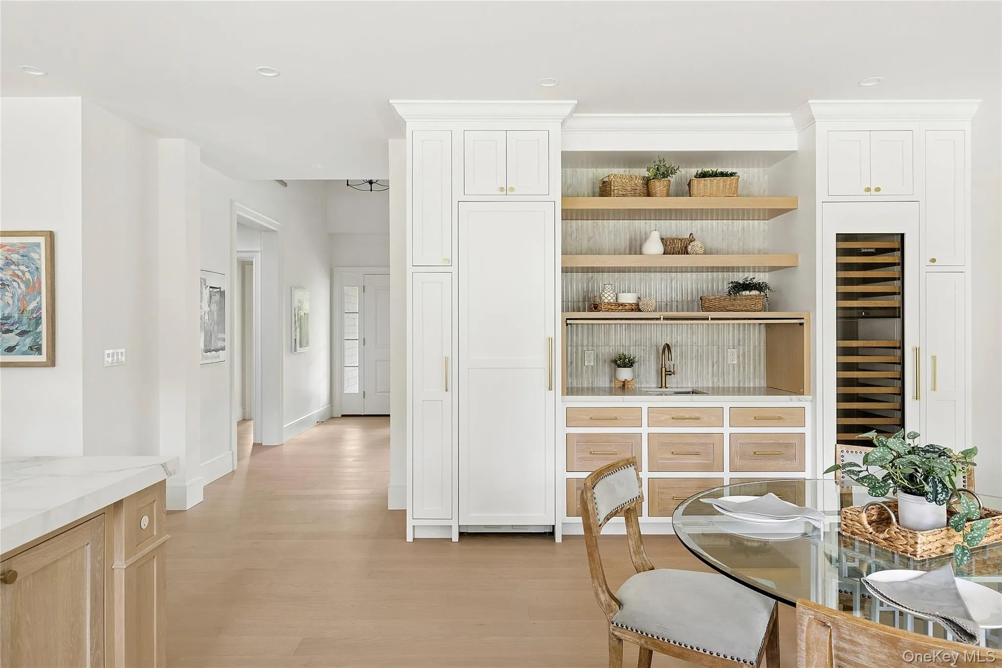Integrated wet bar featuring a single-basin sink, wood-finish shelving, and a built-in beverage cooler Integrated wet bar featuring a single-basin sink, wood-finish shelving, and a built-in beverage cooler