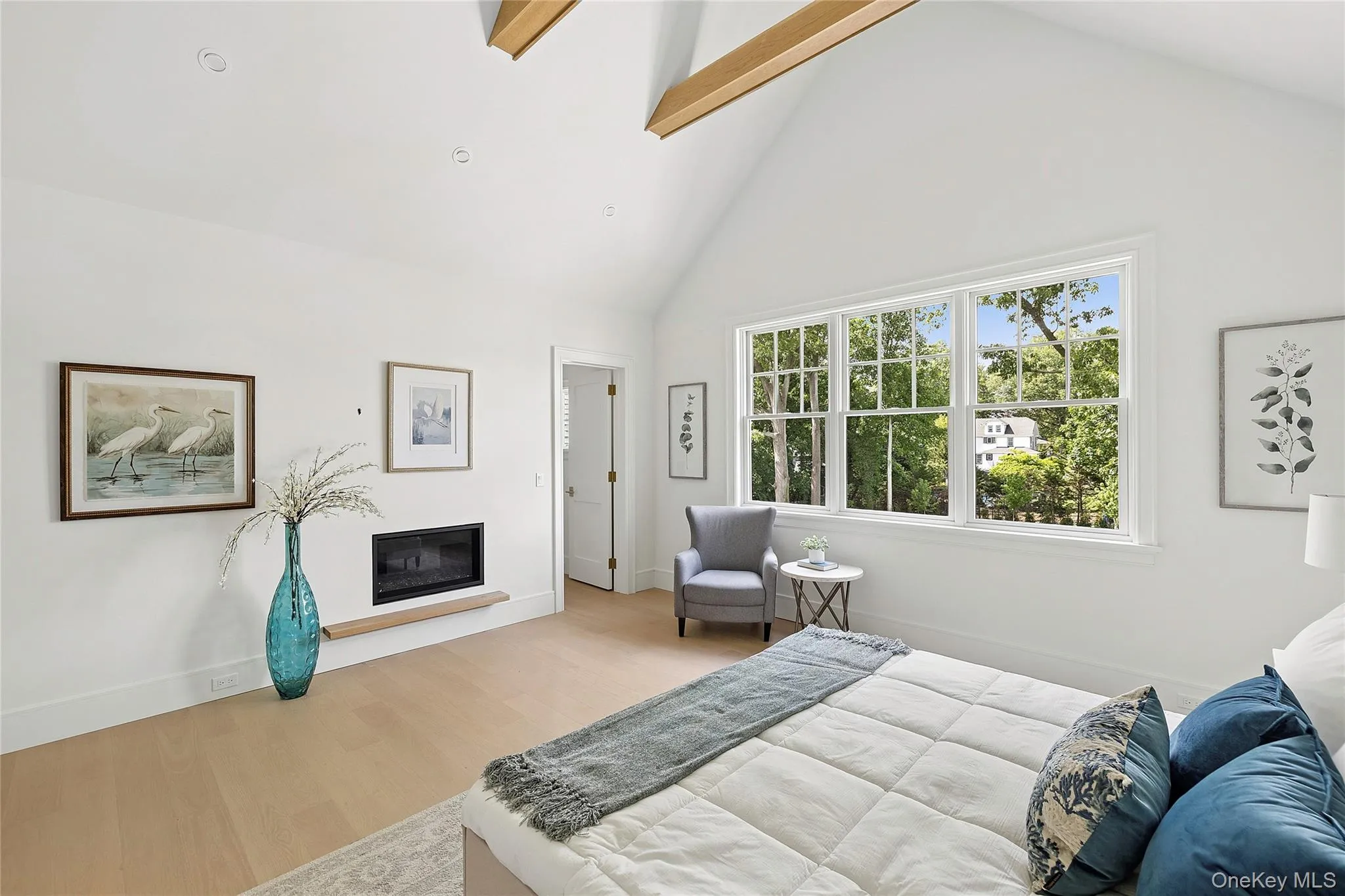 Vaulted ceilings featuring exposed wooden beams, a multi-pane window, wood-finish flooring, a built-in fireplace with a wooden hearth, and recessed lighting Vaulted ceilings featuring exposed wooden beams, a multi-pane window, wood-finish flooring, a built-in fireplace with a wooden hearth, and recessed lighting