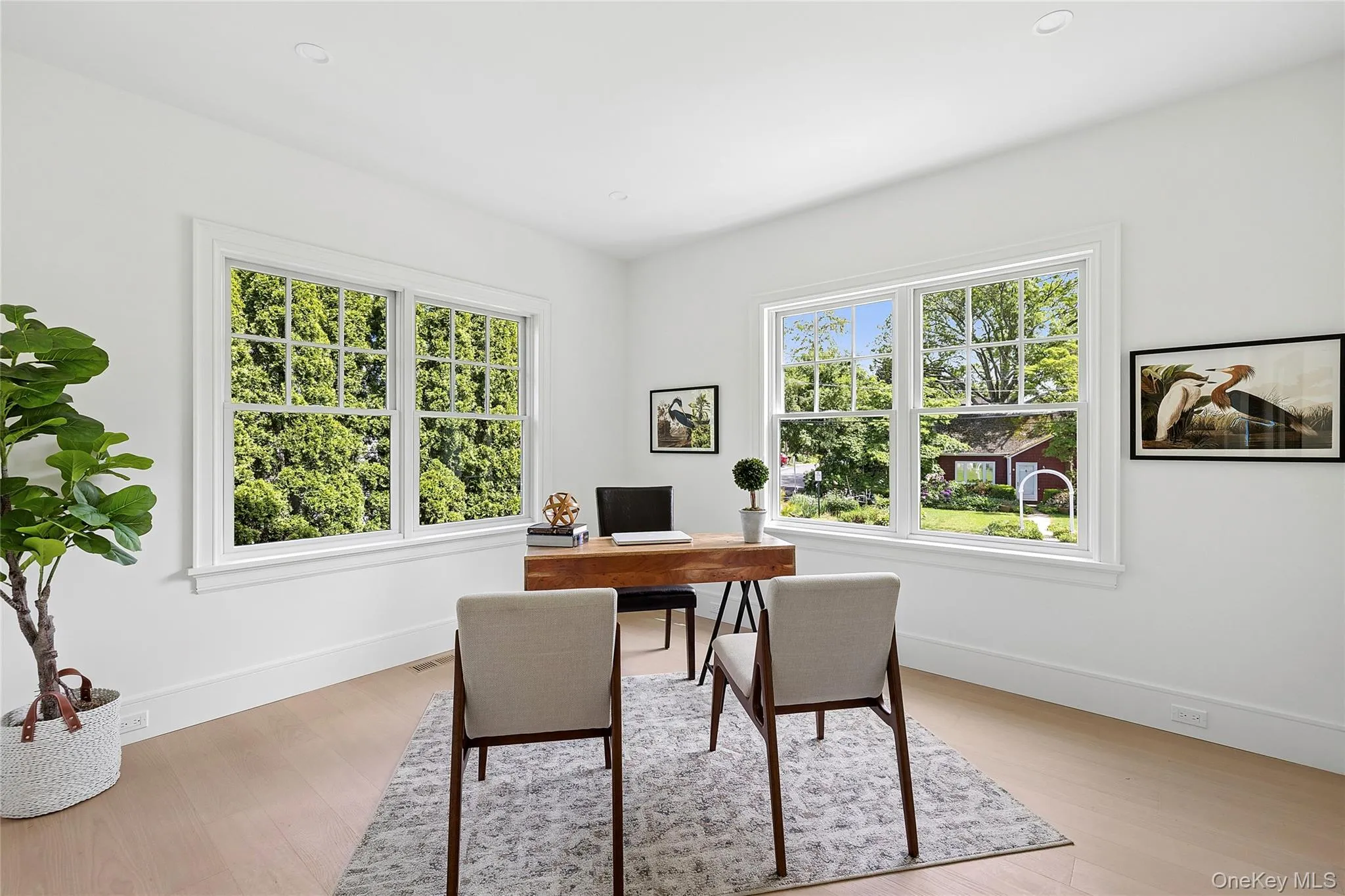 Bright interior space featuring white walls and light wood-finish flooring Bright interior space featuring white walls and light wood-finish flooring