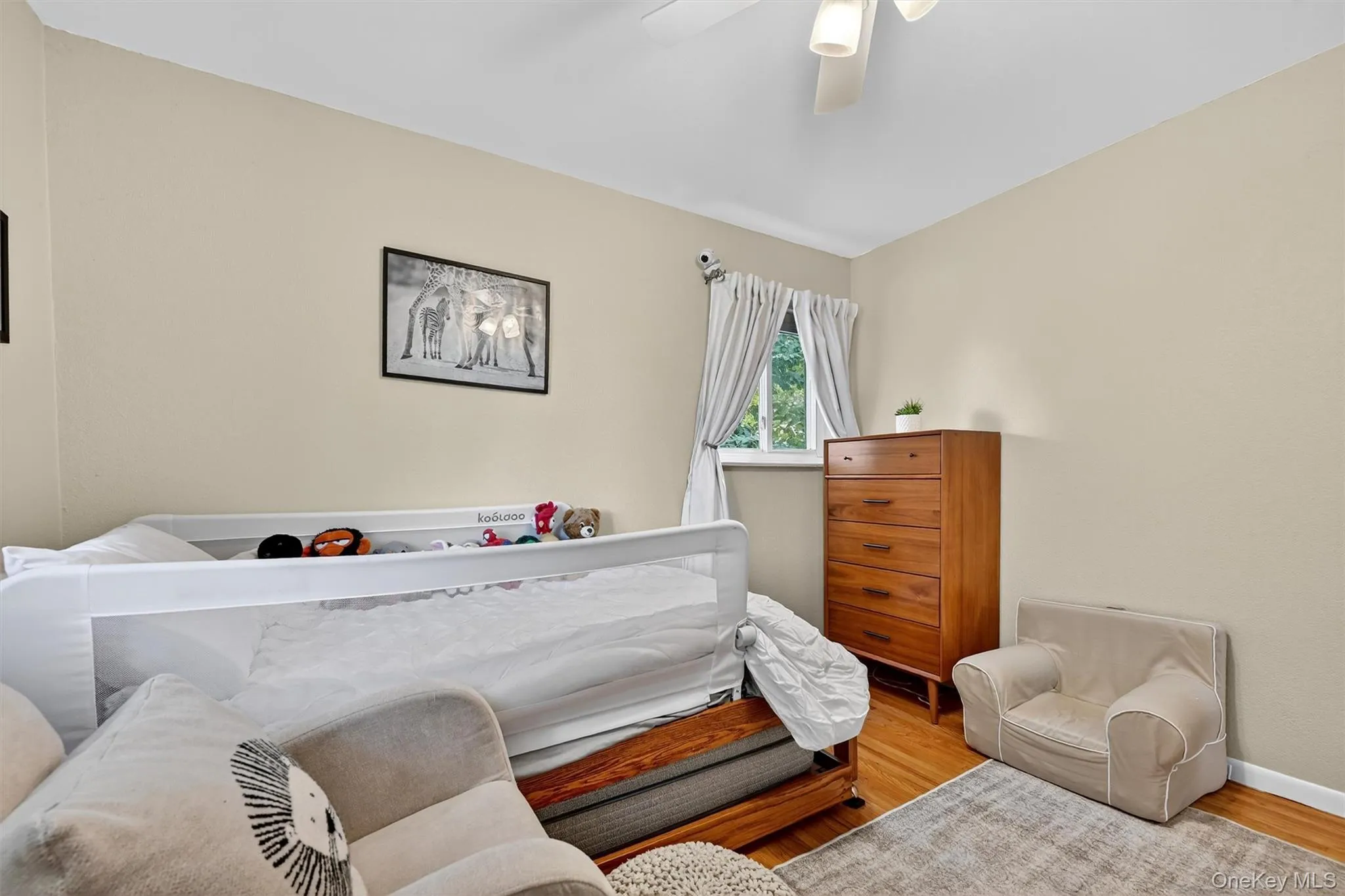 Bedroom featuring wood finished floors and a ceiling fan Bedroom featuring wood finished floors and a ceiling fan