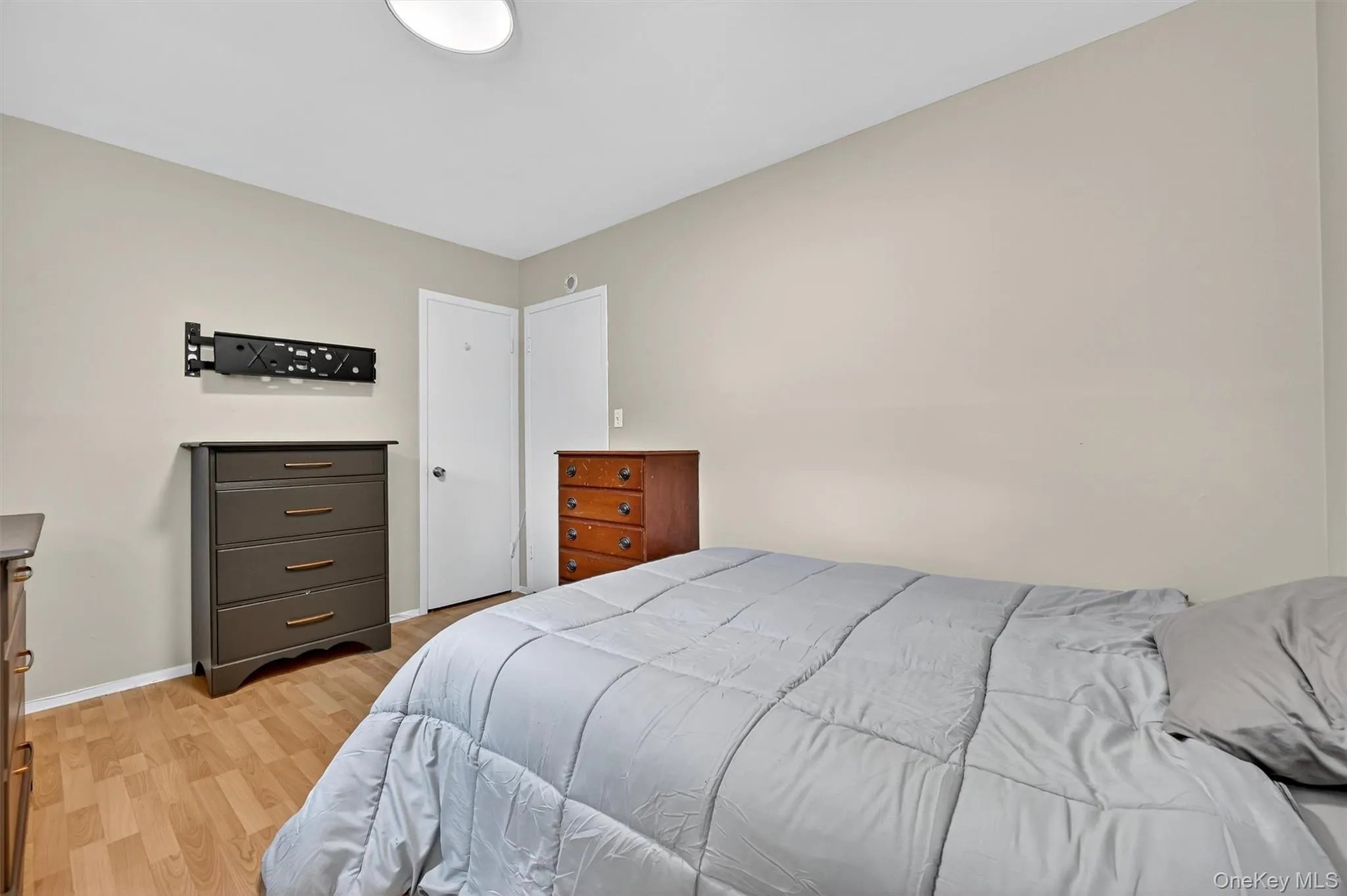 Bedroom featuring light wood-style floors and baseboards Bedroom featuring light wood-style floors and baseboards