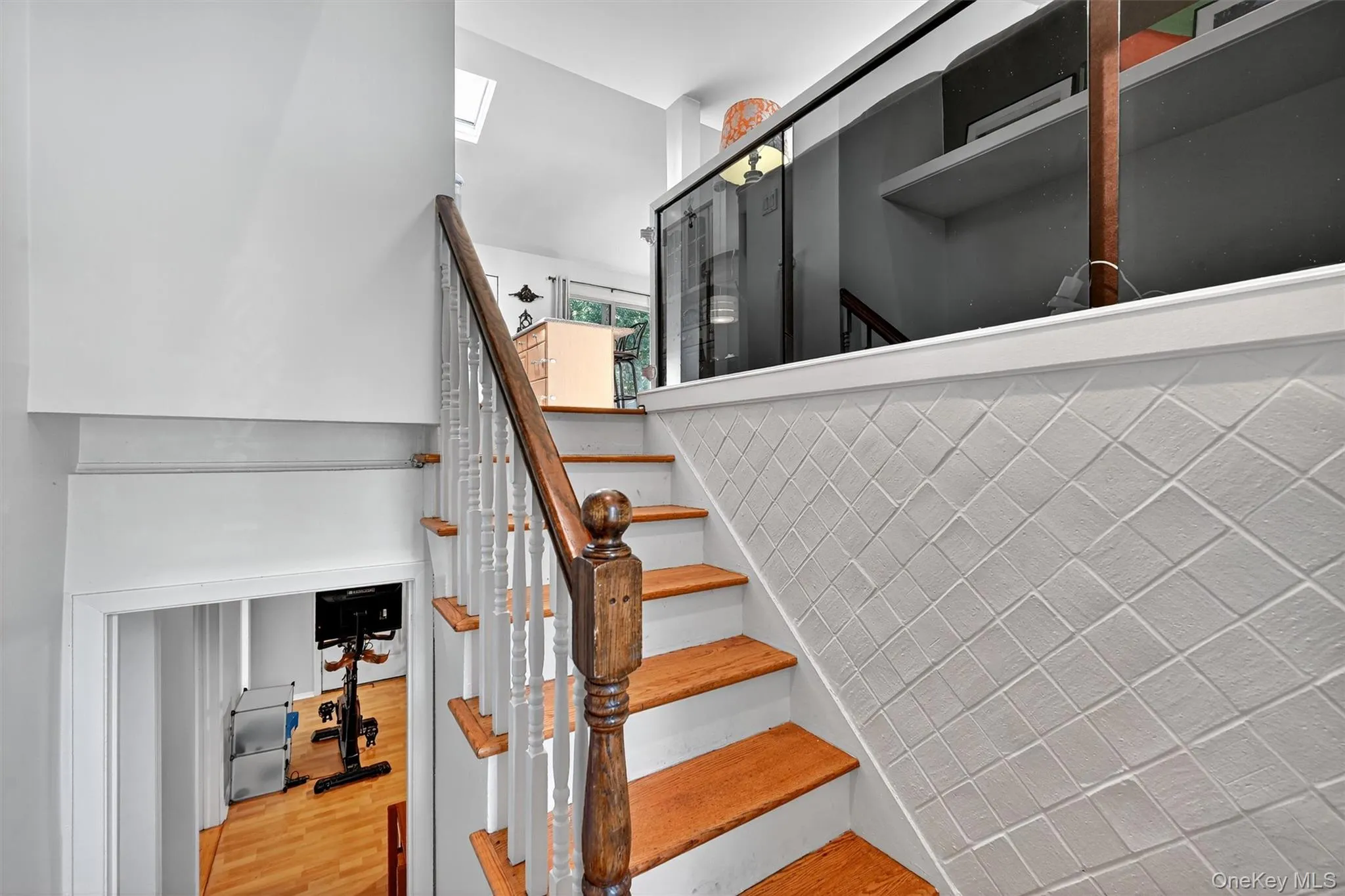 Stairway with wood finished floors and a skylight Stairway with wood finished floors and a skylight