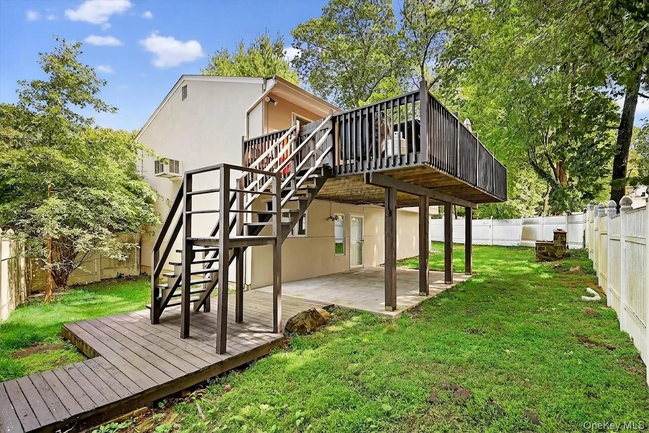Expansive exterior featuring a multi-level deck and a privacy fence Expansive exterior featuring a multi-level deck and a privacy fence