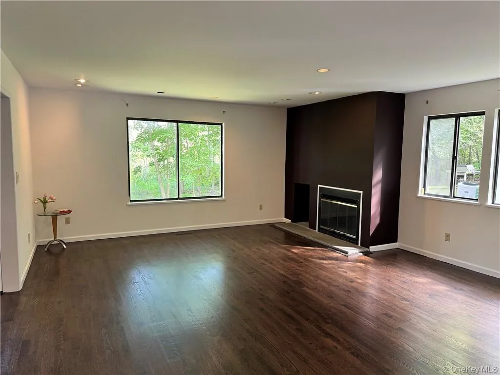 Freshly painted with newly installed dark wood floors! Living room offers wood burning fireplace and is adjacent to den/library/home office Freshly painted with newly installed dark wood floors! Living room offers wood burning fireplace and is adjacent to den/library/home office