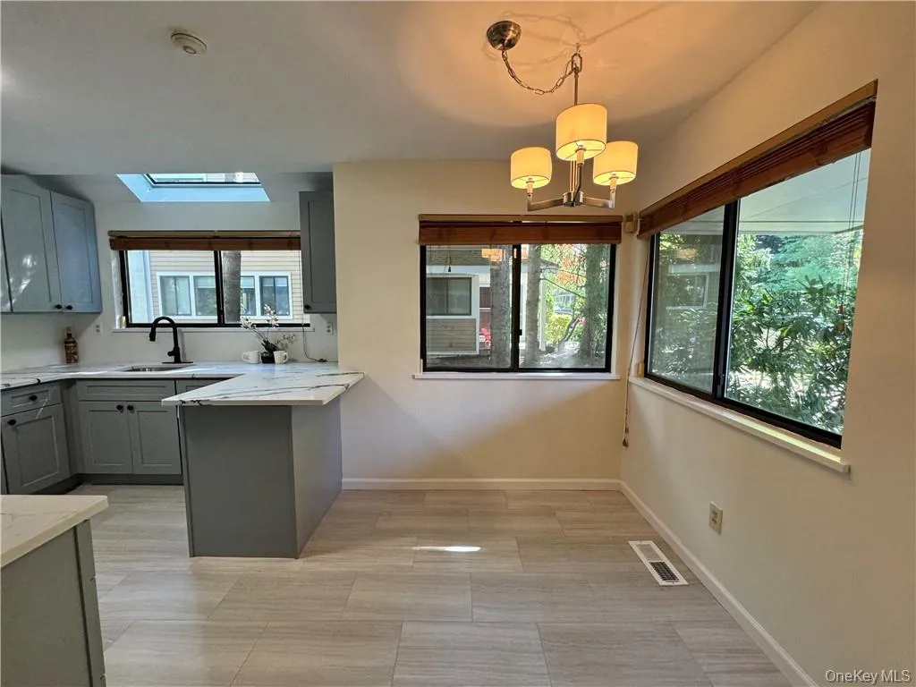 Spacious updated eat in kitchen with large windows providing abundance of natural light Spacious updated eat in kitchen with large windows providing abundance of natural light