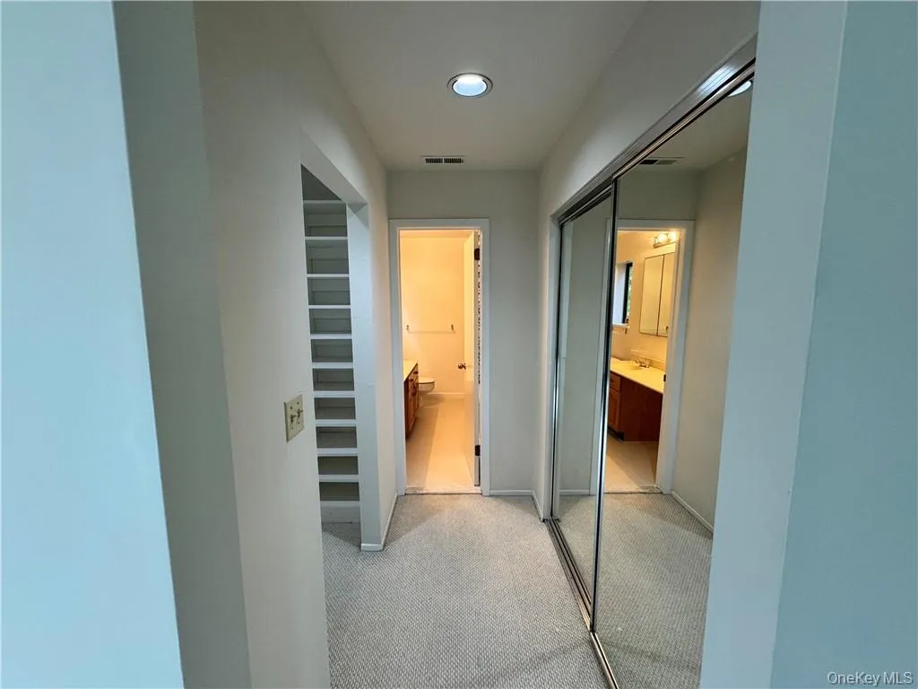 Large walk in closets connecting primary bedroom to primary bath Large walk in closets connecting primary bedroom to primary bath