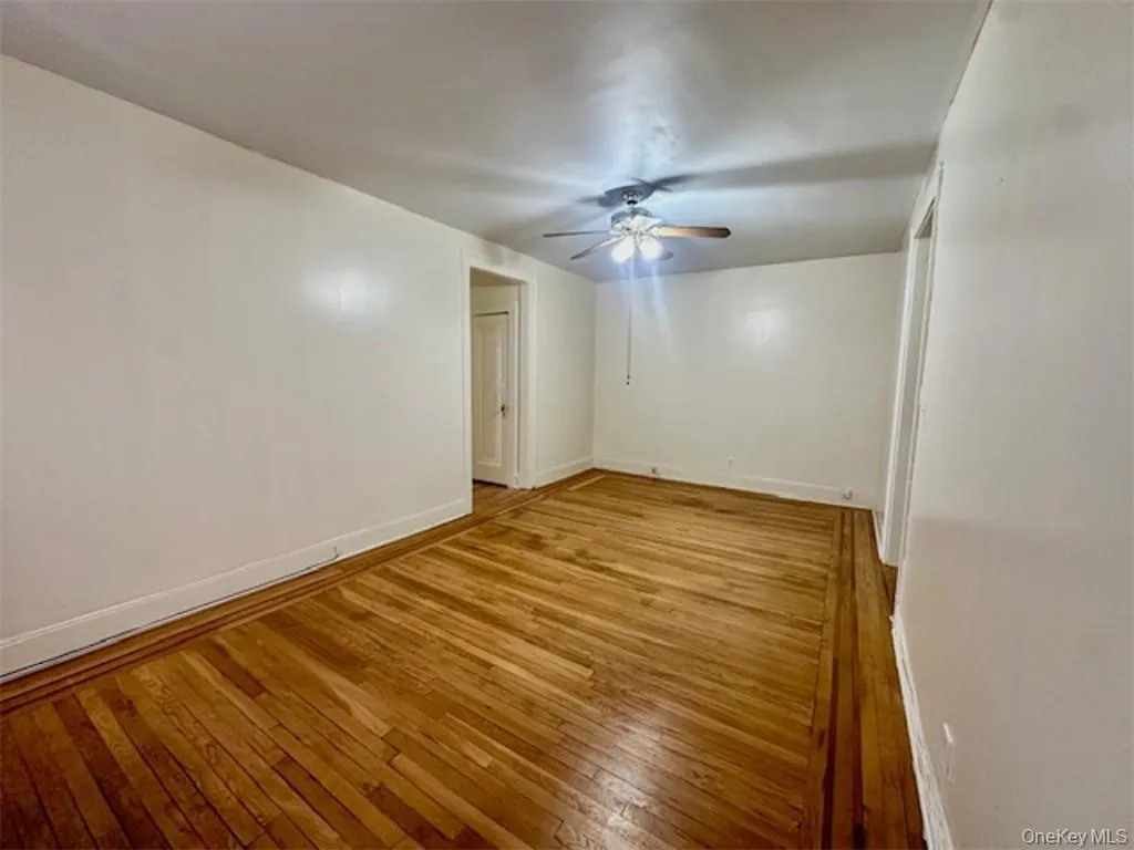 Spare room featuring light wood-type flooring and ceiling fan Spare room featuring light wood-type flooring and ceiling fan