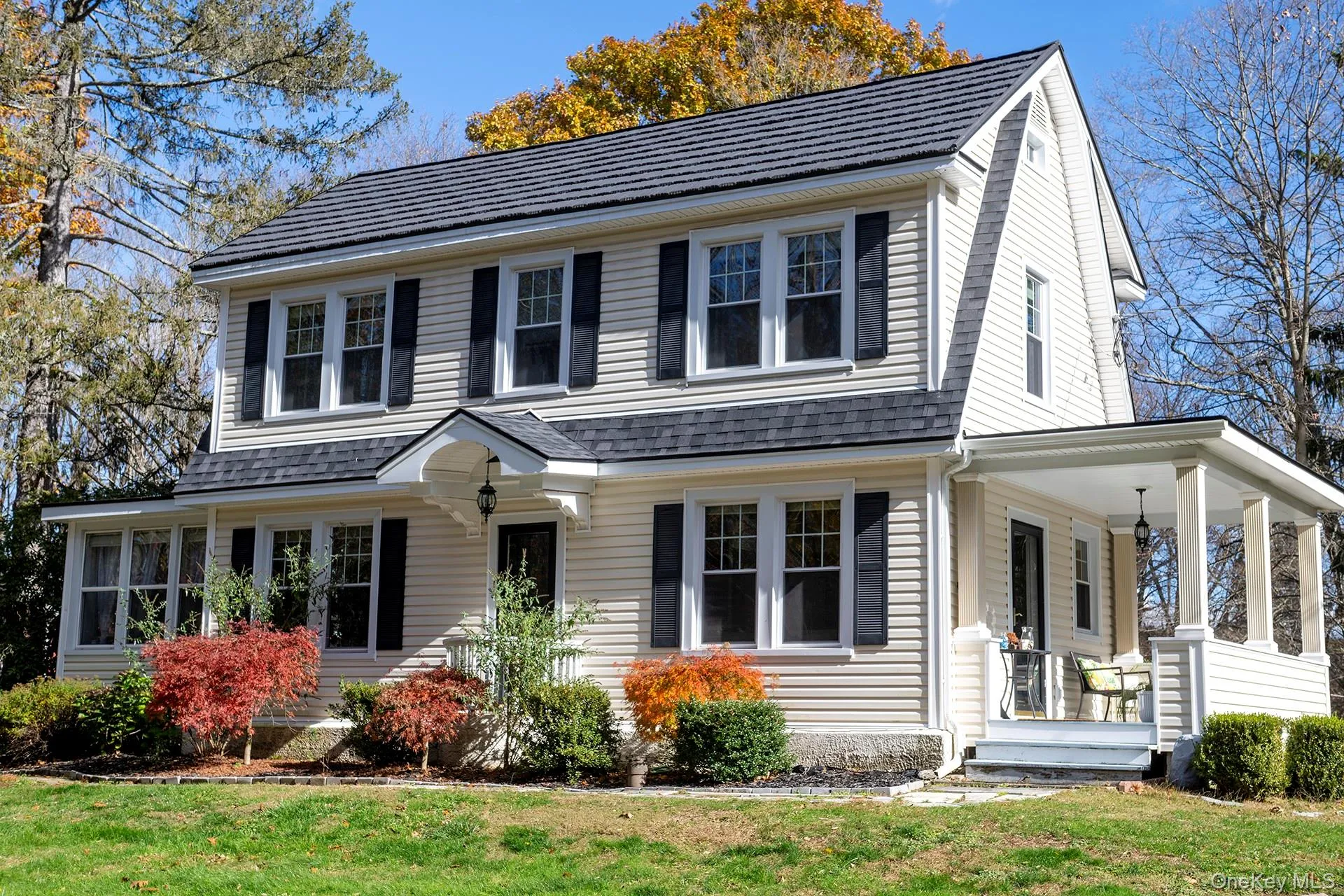 View of front facade featuring a front lawn and a porch View of front facade featuring a front lawn and a porch
