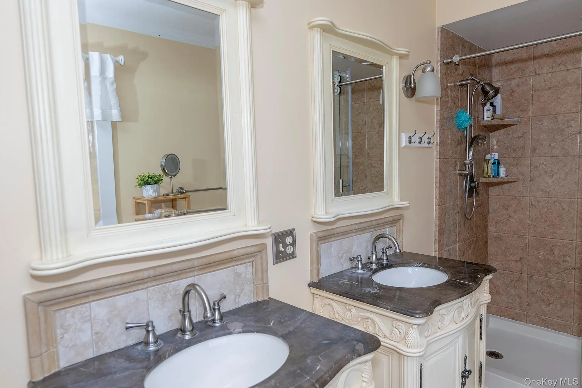 Full bathroom featuring two vanities and tiled shower Full bathroom featuring two vanities and tiled shower