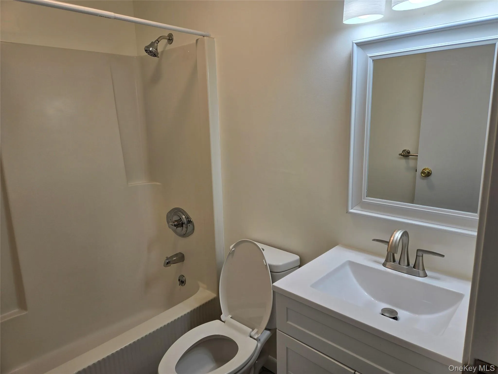 Full bathroom featuring vanity, shower / bath combination, and toilet Full bathroom featuring vanity, shower / bath combination, and toilet