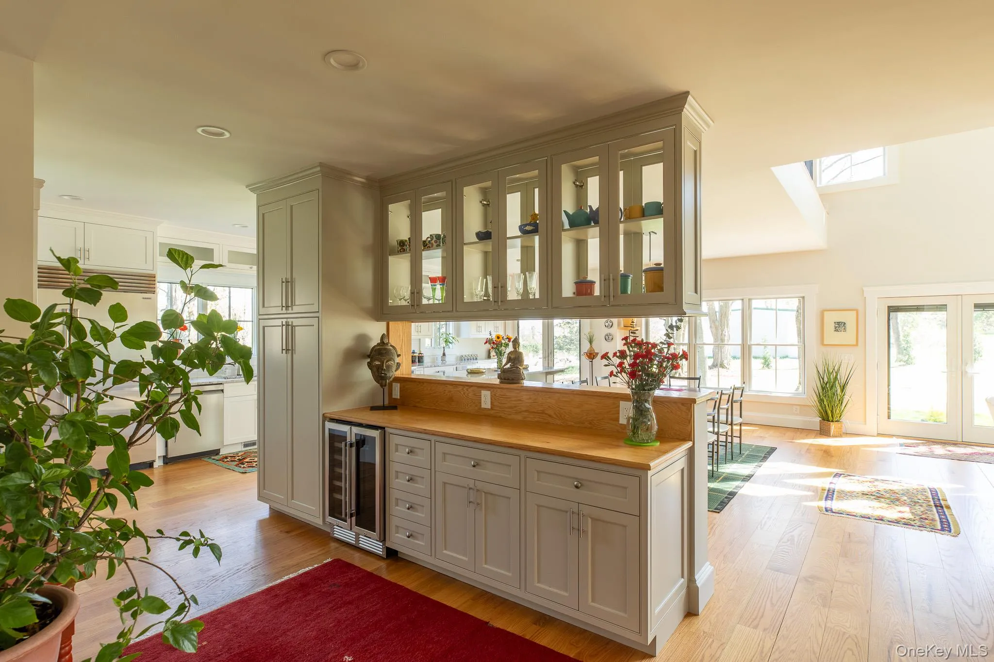 Wet bar with beverage fridge and glass cabinets Wet bar with beverage fridge and glass cabinets