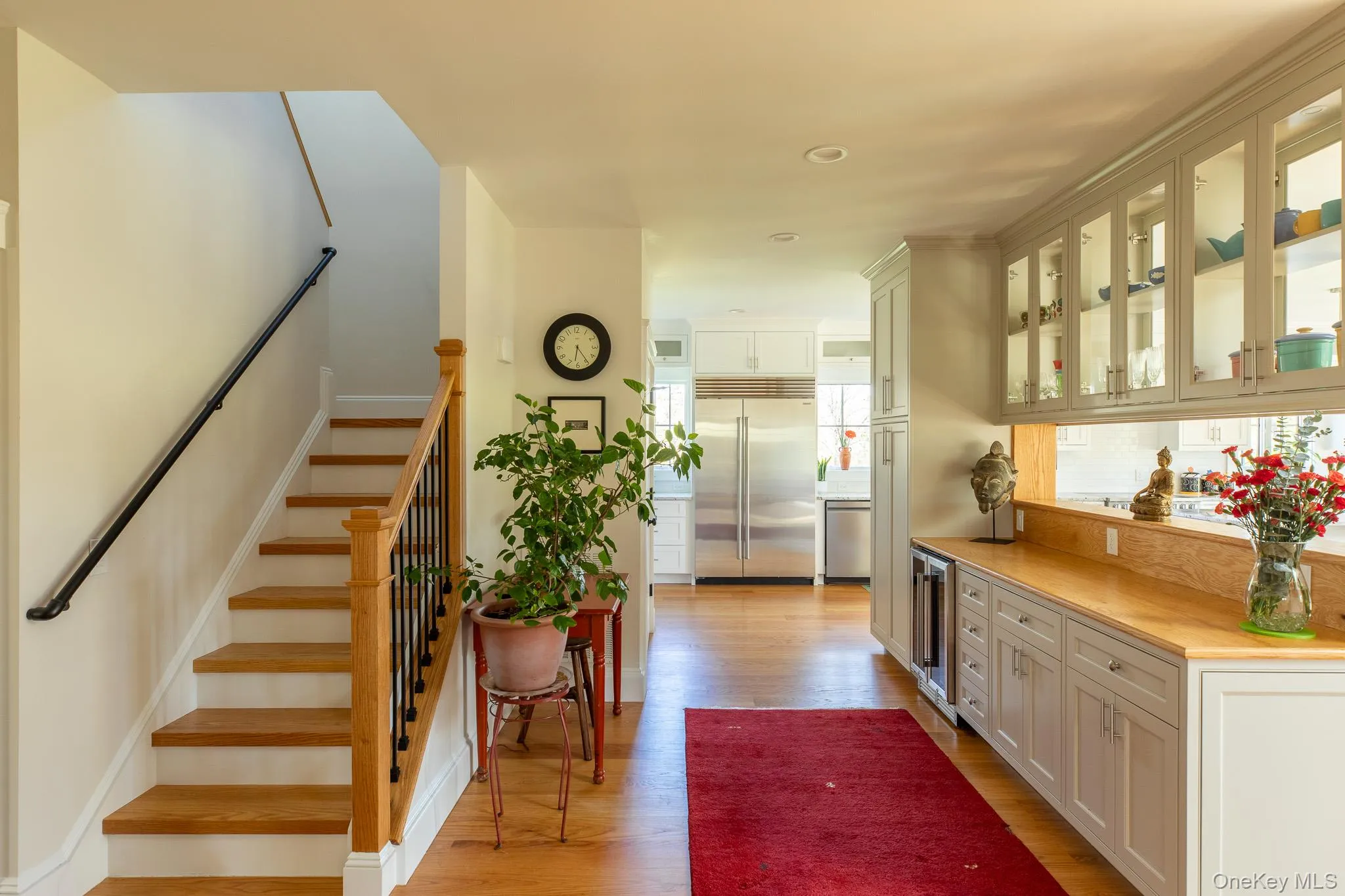 Entrance foyer, with view of the staircase and wet bar Entrance foyer, with view of the staircase and wet bar