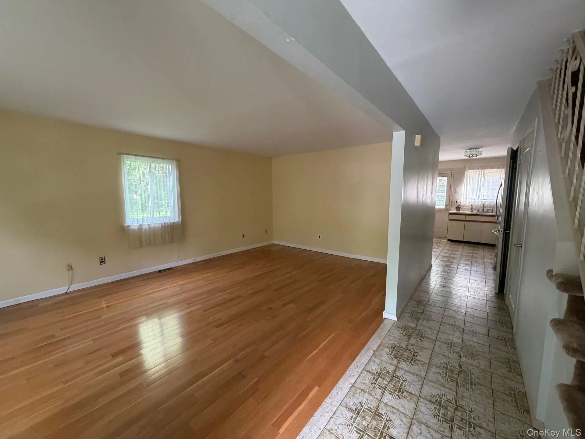 Bright and sunny living room with hallway to kitchen Bright and sunny living room with hallway to kitchen