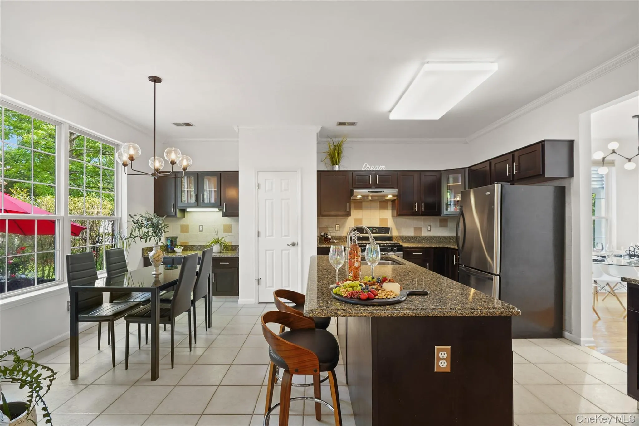 Kitchen with dark wood cabinetry and stainless steel appliances Kitchen with dark wood cabinetry and stainless steel appliances