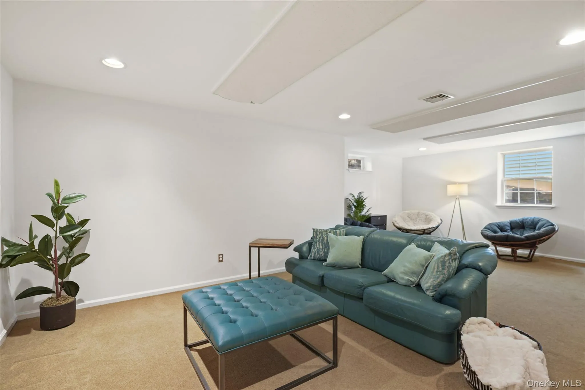 Spacious room featuring neutral carpeting and white wall finishes Spacious room featuring neutral carpeting and white wall finishes